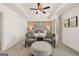 A bright main bedroom with trey ceilings, neutral tones, and a comfortable seating area at 624 Whitman Lane # 2032, Stockbridge, GA 30281