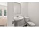 Powder room featuring pedestal sink, and white toilet near doors to other rooms at 624 Whitman Lane # 2032, Stockbridge, GA 30281