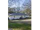 Spacious backyard with well-maintained lawn, patio area, and mature trees offering privacy at 3095 Holbrook Sw Dr, Marietta, GA 30060