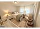 Comfortable bedroom with a single bed, sitting chair, and a fluffy rug for added coziness at 3095 Holbrook Sw Dr, Marietta, GA 30060