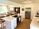 Bright eat-in kitchen with stainless steel appliances, white cabinetry, and flows into the living room at 3095 Holbrook Sw Dr, Marietta, GA 30060