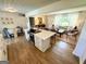 Bright eat-in kitchen with stainless steel appliances, white cabinetry, flows into the living room and dining area at 3095 Holbrook Sw Dr, Marietta, GA 30060