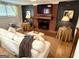 Cozy living room featuring a brick fireplace, neutral furnishings, with built-ins and ample light at 3095 Holbrook Sw Dr, Marietta, GA 30060