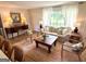 Cozy living room with large window, hardwood floors, and comfortable seating arrangement at 3095 Holbrook Sw Dr, Marietta, GA 30060
