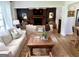 Cozy living room featuring a brick fireplace, neutral furnishings, and ample natural light at 3095 Holbrook Sw Dr, Marietta, GA 30060