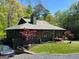 Beautiful home featuring a well manicured lawn and professional landscaping with a glimpse of the side entry garage at 921 Oak Dr, Woodstock, GA 30189