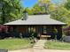 Charming single-story home featuring mature landscaping, well-maintained lawn and attractive front entrance at 921 Oak Dr, Woodstock, GA 30189