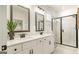 Elegant bathroom featuring double vanity, black hardware, walk-in shower, and modern fixtures at 1818 Butterfly Way, Marietta, GA 30066
