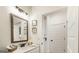 The bathroom has white walls, sleek fixtures, and a mirror, creating a clean and modern space at 1818 Butterfly Way, Marietta, GA 30066