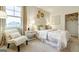 Bright bedroom features white walls, a comfy chair, and a large window for ample natural light at 1818 Butterfly Way, Marietta, GA 30066