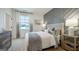 Beautiful bedroom with a decorative gray accent wall, plush bed, and natural light from a window at 1818 Butterfly Way, Marietta, GA 30066