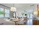 Inviting dining area with a modern chandelier and comfortable seating near large windows at 1818 Butterfly Way, Marietta, GA 30066