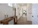 Open hallway showcasing wood floors, decorative wall paneling, and a glimpse of the combined living and dining areas at 1818 Butterfly Way, Marietta, GA 30066
