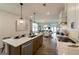 Open-concept kitchen with an island, modern appliances, and a seamless view into the living and dining spaces at 1818 Butterfly Way, Marietta, GA 30066