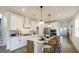 Bright, modern kitchen with an island, stainless steel appliances, white cabinets, and stylish pendant lighting at 1818 Butterfly Way, Marietta, GA 30066