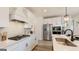 Modern white kitchen features stainless steel appliances, quartz countertops, and a stylish backsplash at 1818 Butterfly Way, Marietta, GA 30066