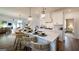 Well-lit kitchen featuring a central island with seating, modern pendant lighting, and seamless transition to dining area at 1818 Butterfly Way, Marietta, GA 30066