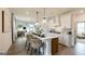 Spacious kitchen with a large island, modern appliances, pendant lighting, and a view into the dining and living areas at 1818 Butterfly Way, Marietta, GA 30066