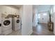 Convenient laundry room with modern washer and dryer, complemented by stylish patterned tile flooring at 1818 Butterfly Way, Marietta, GA 30066