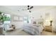 Bright main bedroom with paneled wall, ceiling fan, and seating area near sunny window at 1818 Butterfly Way, Marietta, GA 30066