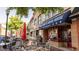 Charming outdoor seating at a Marietta restaurant with a blue awning, vibrant red umbrellas and cheerful atmosphere at 1818 Butterfly Way, Marietta, GA 30066