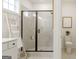 Stylish shower with black frame, glass door, and decorative ladder with neatly folded towels at 1818 Butterfly Way, Marietta, GA 30066