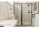 Modern shower with sleek black frame, built-in bench, and decorative ladder with towels at 1818 Butterfly Way, Marietta, GA 30066