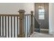 Staircase features oak handrail and modern, geometric wall paneling at 1818 Butterfly Way, Marietta, GA 30066
