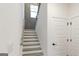 Bright staircase with wood handrail and white risers, offering a modern design at 1818 Butterfly Way, Marietta, GA 30066
