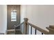 Staircase features oak handrail and modern, geometric wall paneling at 1818 Butterfly Way, Marietta, GA 30066