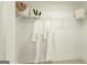 Walk-in closet with hanging rods, wire shelves, and white bathrobes at 1818 Butterfly Way, Marietta, GA 30066