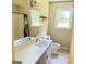 Bathroom featuring a single sink vanity, toilet, mirror, tub, shower, and window at 401 Mt. Tabor Church Rd., Dallas, GA 30157