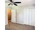 Bedroom featuring carpet flooring, a ceiling fan, a closet, and an open door at 401 Mt. Tabor Church Rd., Dallas, GA 30157