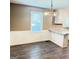 Light-filled dining area featuring wood-look floors, white wainscotting, and a modern chandelier at 401 Mt. Tabor Church Rd., Dallas, GA 30157