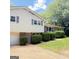 Split level home featuring brick and vinyl siding, a garage, and manicured shrubs at 401 Mt. Tabor Church Rd., Dallas, GA 30157