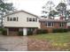 Split level home featuring brick and vinyl siding, a garage, and manicured shrubs at 401 Mt. Tabor Church Rd., Dallas, GA 30157