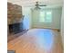 Living room featuring a brick fireplace, wood-look flooring, and a window at 401 Mt. Tabor Church Rd., Dallas, GA 30157