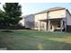 Well-manicured backyard with a covered patio, swing set, and trampoline, perfect for outdoor activities at 878 W Union Grove Cir, Auburn, GA 30011