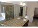 Bathroom with granite countertops, glass enclosed shower and soaking tub, neutral tile and dark wood cabinets at 878 W Union Grove Cir, Auburn, GA 30011