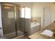 Bathroom featuring glass shower, soaking tub, and granite countertop vanity with a neutral palette at 878 W Union Grove Cir, Auburn, GA 30011