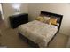 Cozy bedroom with a queen size bed, black dresser, and contemporary lamp for soft lighting at 878 W Union Grove Cir, Auburn, GA 30011