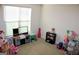 Play room with window, neutral colored walls and carpet, and play sets at 878 W Union Grove Cir, Auburn, GA 30011