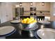 Close-up view of the dining table with black chairs and decorative bowl of lemons at 878 W Union Grove Cir, Auburn, GA 30011