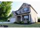 Corner lot featuring a two-story home with manicured lawn and tree lined perimeter at 878 W Union Grove Cir, Auburn, GA 30011