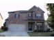 Charming two-story home with a brick and siding facade, well-maintained landscaping, and an attached two-car garage at 878 W Union Grove Cir, Auburn, GA 30011