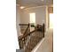 Upstairs hallway with wooden banister and view into the bedroom at 878 W Union Grove Cir, Auburn, GA 30011