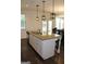 Bright kitchen island with granite countertop, stainless steel dishwasher, and pendant lighting at 878 W Union Grove Cir, Auburn, GA 30011