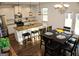 Bright kitchen features granite countertops, stainless steel appliances, island, and pendant lighting at 878 W Union Grove Cir, Auburn, GA 30011