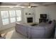Open concept living room with fireplace, coffered ceilings, and a large couch at 878 W Union Grove Cir, Auburn, GA 30011