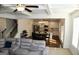Open-concept living room flows into a kitchen with white cabinets and stainless steel appliances at 878 W Union Grove Cir, Auburn, GA 30011